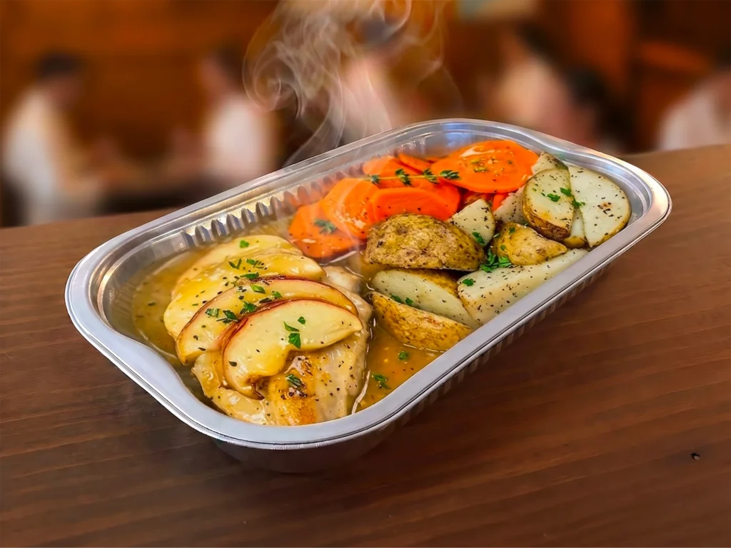 Plateau fumant de poulet, pommes de terre et légumes